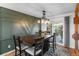Inviting dining room featuring a stylish accent wall, wood table, and access to the outdoor deck at 1261 Eagle St, Aurora, CO 80011