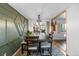 Dining room with hardwood floors, an accent wall, and a sliding glass door at 1261 Eagle St, Aurora, CO 80011