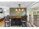 Well-lit dining area showcasing an elegant light fixture and direct access to the outdoor deck at 1261 Eagle St, Aurora, CO 80011