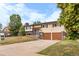 Inviting home with a spacious driveway leading to an attached two-car garage at 1261 Eagle St, Aurora, CO 80011