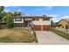 Charming two-story home with an attached two-car garage and solar panels on the roof at 1261 Eagle St, Aurora, CO 80011