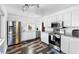 Bright kitchen featuring stainless steel appliances, white cabinetry and dark modern flooring at 1261 Eagle St, Aurora, CO 80011