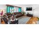 Cozy living room with a comfortable leather sofa, hardwood flooring, and natural light at 1261 Eagle St, Aurora, CO 80011