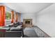 Bright living room with a gray sectional sofa, fireplace, and sunny windows at 1261 Eagle St, Aurora, CO 80011