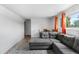 Inviting living room with a comfortable gray sectional sofa, dining table and stylish blue rug at 1261 Eagle St, Aurora, CO 80011