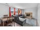 Comfortable living room with a gray sectional sofa, dining table, fireplace, and bright windows at 1261 Eagle St, Aurora, CO 80011