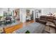 Open-concept living space with hardwood floors seamlessly connecting the living and dining areas at 1261 Eagle St, Aurora, CO 80011