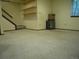 Carpeted basement featuring open shelving and natural lighting from a window at 21734 Farmingdale Ct, Parker, CO 80138