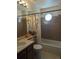 Bathroom with shower-tub combination, tiled walls, vanity with sink and a small window at 21734 Farmingdale Ct, Parker, CO 80138