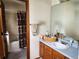 Bathroom featuring wood vanity, shower with decorative curtain and large mirror at 21734 Farmingdale Ct, Parker, CO 80138