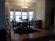 Bright dining room featuring a large bay window, dark wood table and chairs, plus decorative rug at 21734 Farmingdale Ct, Parker, CO 80138
