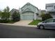 Home exterior with two-car garage and a car parked out front on a cloudy day in the neighborhood at 21734 Farmingdale Ct, Parker, CO 80138
