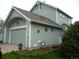 Charming two-story home with sage green siding, attached garage, and delightful garden accents at 21734 Farmingdale Ct, Parker, CO 80138