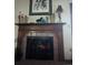 Cozy fireplace with decorative mantle, tile surround, and ornate fire screen in a warm living space at 21734 Farmingdale Ct, Parker, CO 80138
