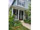 Charming front porch adorned with flowers, and trailing vines creating a welcoming entrance at 21734 Farmingdale Ct, Parker, CO 80138