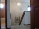 Carpeted hallway featuring a view into the bathroom, stairs and chandelier at 21734 Farmingdale Ct, Parker, CO 80138