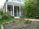 Charming home exterior with landscaped front yard featuring columns, porch, and colorful flower beds at 21734 Farmingdale Ct, Parker, CO 80138