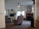 Spacious living room with a fireplace, comfortable seating, and built-in shelving at 21734 Farmingdale Ct, Parker, CO 80138