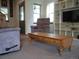 Cozy living room with comfortable seating, a wooden coffee table, and a built-in bookshelf at 21734 Farmingdale Ct, Parker, CO 80138