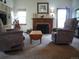 Cozy living room featuring comfortable seating, a fireplace, and natural light from the windows at 21734 Farmingdale Ct, Parker, CO 80138