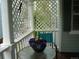Charming front porch featuring decorative lattice, a glass table with flower pot and an aquamarine chair at 21734 Farmingdale Ct, Parker, CO 80138