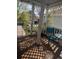 Comfortable front porch featuring a glass table and aquamarine chair with lattice screen, offering curb appeal at 21734 Farmingdale Ct, Parker, CO 80138