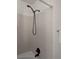Tiled shower featuring modern black shower head fixture and minimalist design at 21734 Farmingdale Ct, Parker, CO 80138