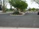 View of a landscaped traffic roundabout leading to a community park and trails on a sunny day at 21734 Farmingdale Ct, Parker, CO 80138