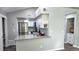 Well-lit kitchen boasts white cabinets, stainless steel appliances, and a convenient breakfast bar for casual dining at 4760 S Wadsworth Blvd # 205, Littleton, CO 80123