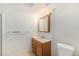 This bathroom features a wooden vanity with storage and a sink, with vanity lights and a mirror at 8191 Tennyson St, Westminster, CO 80031