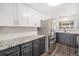 Well-lit kitchen featuring stainless steel appliances, gray cabinetry, and granite countertops at 8191 Tennyson St, Westminster, CO 80031
