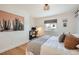 Bedroom with wood floors, a queen bed, and a large cactus print at 7505 Robinson Way, Arvada, CO 80003