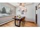 Dining area with wood floors, modern table and gallery wall at 7505 Robinson Way, Arvada, CO 80003