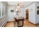 Bright dining room with wood floors, a wooden table, and gallery wall at 7505 Robinson Way, Arvada, CO 80003