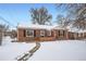 Brick ranch home with snow-covered yard at 7505 Robinson Way, Arvada, CO 80003