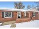 Brick ranch home exterior, winter scene at 7505 Robinson Way, Arvada, CO 80003