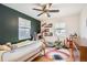 Cozy bedroom with built-in shelving and a rainbow rug at 7505 Robinson Way, Arvada, CO 80003