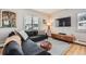 Living room with sectional sofa and wood floors at 7505 Robinson Way, Arvada, CO 80003