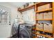 Laundry room with washer, dryer, and ample storage at 7505 Robinson Way, Arvada, CO 80003