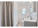 Clean bathroom with a gray vanity and shower/tub combo at 7505 Robinson Way, Arvada, CO 80003