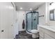 Updated bathroom with tiled walk-in shower, modern fixtures, and convenient washer/dryer for added functionality at 6220 W 11Th Pl, Lakewood, CO 80214