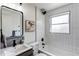 Modern bathroom featuring a sleek vanity, tub, and tiled shower at 6220 W 11Th Pl, Lakewood, CO 80214