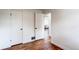 Bedroom featuring light walls, refinished wood floors, and view to another room at 6220 W 11Th Pl, Lakewood, CO 80214