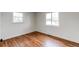 Bright bedroom with refinished wood floors and two windows providing natural light at 6220 W 11Th Pl, Lakewood, CO 80214