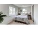 Cozy bedroom with two windows, patterned bedspread, and neutral-toned walls for a relaxing atmosphere at 6220 W 11Th Pl, Lakewood, CO 80214