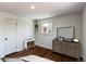 A serene bedroom featuring light walls and refinished wood floors at 6220 W 11Th Pl, Lakewood, CO 80214