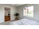 Bright bedroom features a light colored wall and trim, large window with view to the neighborhood and hardwood floor at 6220 W 11Th Pl, Lakewood, CO 80214