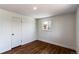 A bright bedroom featuring light walls, refinished wood floors, and large window at 6220 W 11Th Pl, Lakewood, CO 80214
