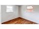 Bright bedroom with refinished wood floors and two windows providing natural light at 6220 W 11Th Pl, Lakewood, CO 80214