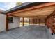 An attached carport with wooden beams, privacy screen and concrete flooring is shown at 6220 W 11Th Pl, Lakewood, CO 80214
